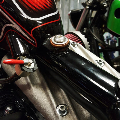 A close up of a motorcycle engine with Universal Frisco Gas Tank Mounting Kit by TC Bros mild steel tophat bungs.