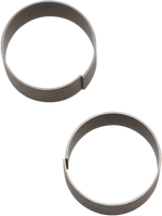 Two Moto Iron® 39mm Fork Tube Bushings, measuring .778" wide, are elegantly arranged on a pristine white background, evoking the charm of a Sportster.