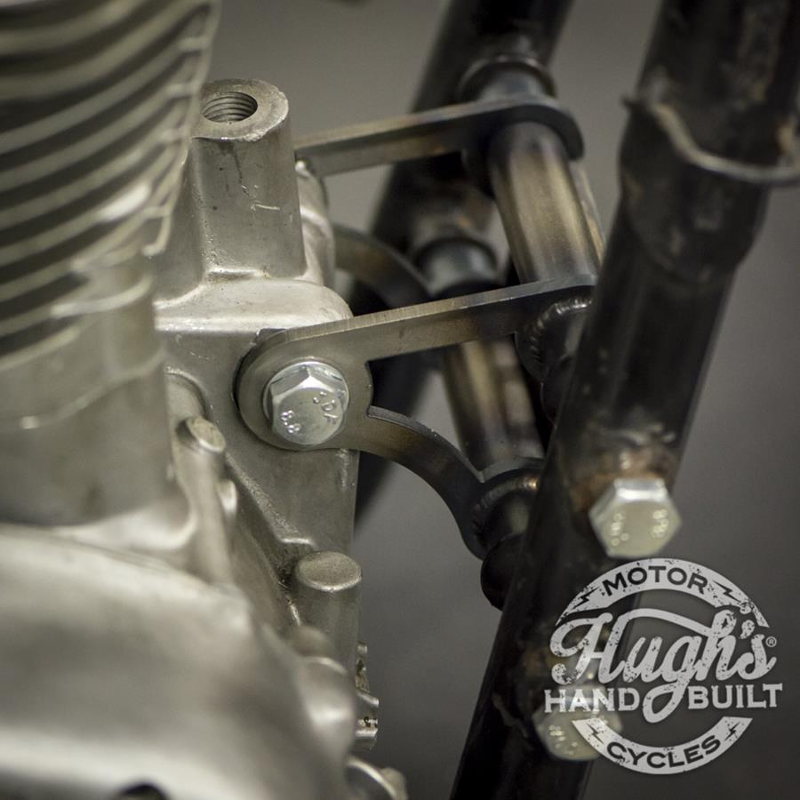 A close up of a motorcycle engine with a Hughs HandBuilt XS650 Motor Mount Kit (74-Up) chassis and Motor Mounts.