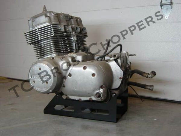 A TC Bros. Honda CB750 Engine Stand with a Honda SOHC CB750 engine on it in a garage.