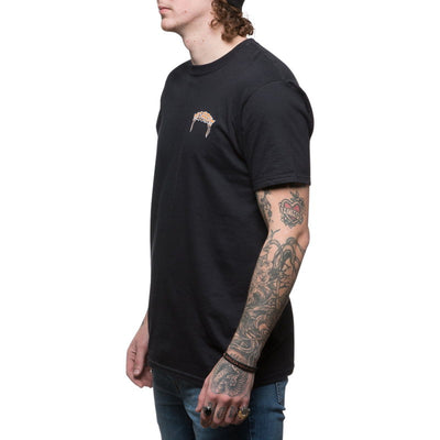 A man with tattoos wearing a TC Bros. Trippin' T-Shirt in black by TC Bros.