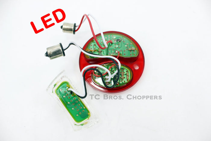 A red TC Bros. LED Conversion Lens for Ford Duolamp Model A Tail Lights board with wires and a battery, upgraded with TC Bros. Ford Duolamp Model A Tail Lights for a sleek conversion.