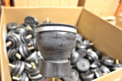 A box full of TC Bros. black rubber TC Bros. Choppers Air Spring parts in a warehouse.