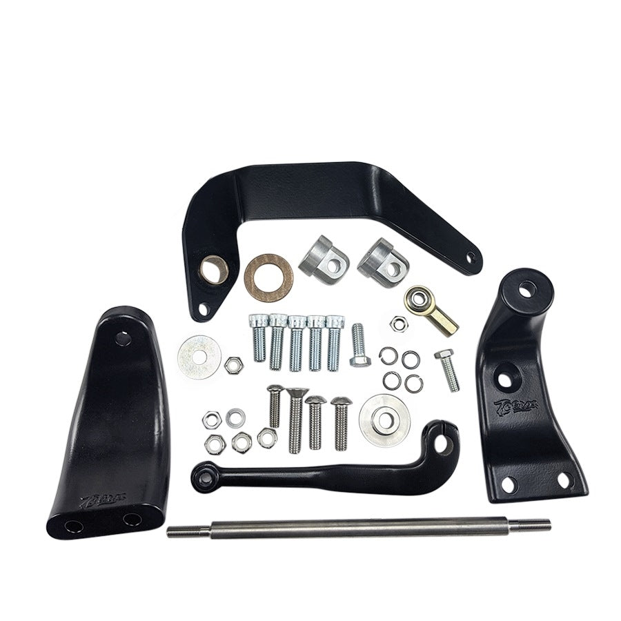 A TC Bros. Mid Controls Kit for 1991-2017 Harley-Davidson Dyna (no footpegs), featuring black metal brackets, assorted bolts, washers, nuts, bushings, and a metal rod arranged on a white background.