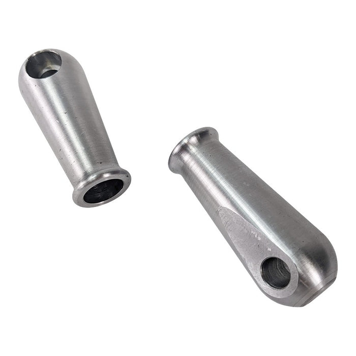 Two TC Bros. Sissy Bar/Fender Strut Mounting Bungs, cylindrical with holes at one end, are positioned crossing each other on a white background.