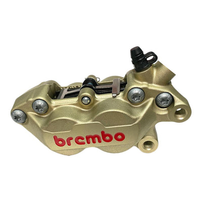 A Brembo P4 Axial Brake Caliper Right Side Gold 4 Piston on a white background.
