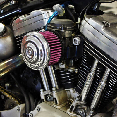 A close up of a TC Bros. Ripple Polished Air Cleaner with an S&S Super E & G Carbs vintage motorcycle engine.