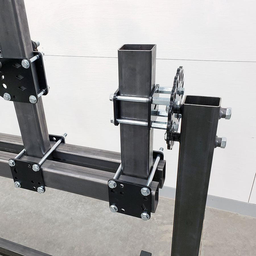 A DIY Frame Jig Rotisserie Stand by Chop Source, a metal frame with several bolts attached to it, is used for welding and as a motorcycle frame jig.