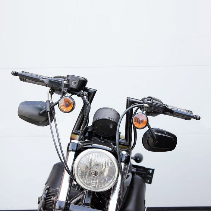 Two TC Bros. 1" Slant Z Handlebars—one chrome, one black—are shown parallel on a white background. Ideal for custom Harley or chopper upgrades, these quality bars are crafted by TC Bros.