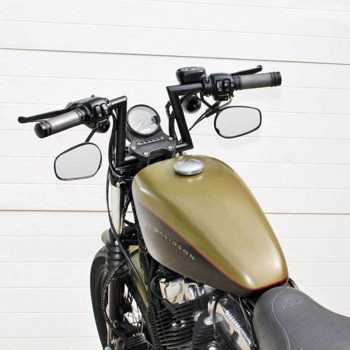 Two TC Bros. 1" Slant Z Handlebars—one chrome, one black—are shown parallel on a white background. Ideal for custom Harley or chopper upgrades, these quality bars are crafted by TC Bros.