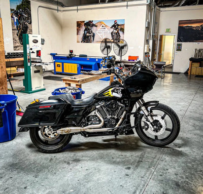 A black SP Concepts M8 Touring FLT motorcycle parked in a garage.