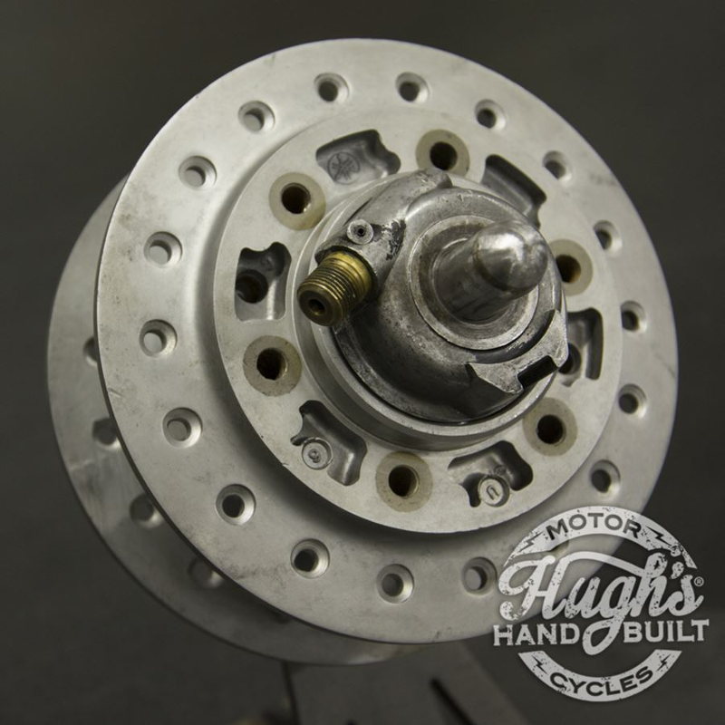 A close up of a metal wheel with a hole in it, perfect for those interested in Hughs HandBuilt Yamaha XS650 Speedometer Eliminator (fits 1975-1983) customization.
