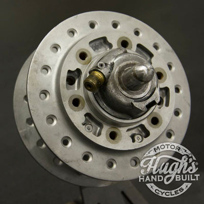 A close up of a metal wheel with a hole in it, perfect for those interested in Hughs HandBuilt Yamaha XS650 Speedometer Eliminator (fits 1975-1983) customization.