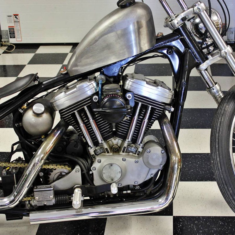 A vintage style black and silver motorcycle sits on a checkered floor with a TC Bros. Streamliner Black Air Cleaner S&S Super E & G Carbs by TC Bros.