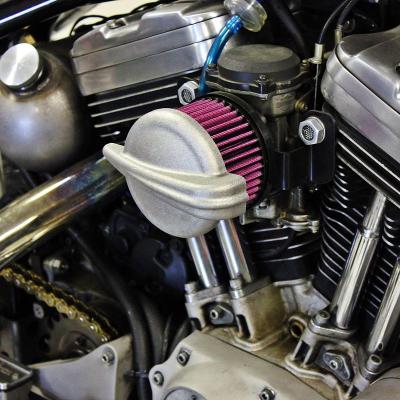 A close up of a motorcycle engine with a TC Bros. Streamliner Raw Air Cleaner for S&S Super E & G Carbs.