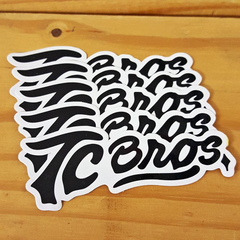 A set of TC Bros. Script Stickers - 5 Pack made of premium vinyl with the word &