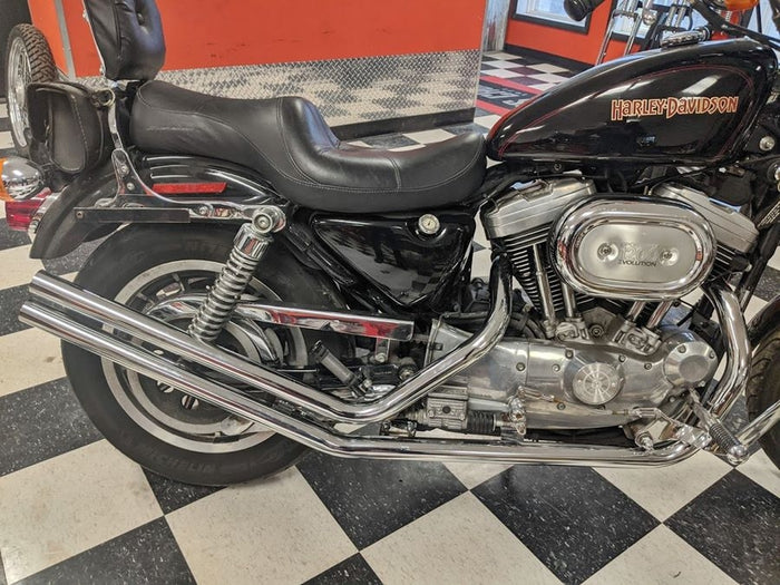 Moto Iron® Upsweep Exhaust System for Harley-Davidson Sportster 1986-2003 shown in chrome with mounting brackets and hardware, ideal for adding custom chopper style. Displayed on a white background.