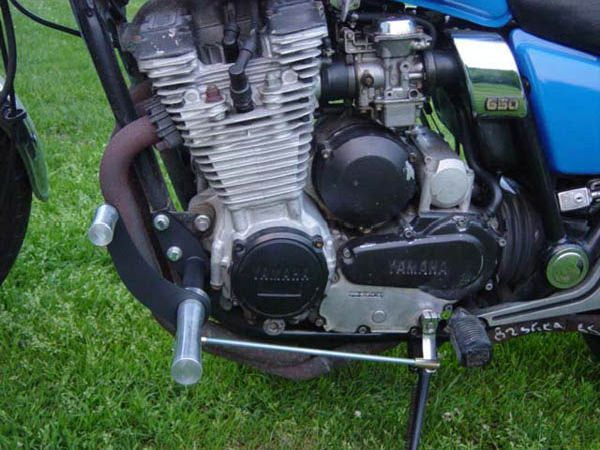 A TC Bros. Yamaha Maxim XJ650 Forward Controls Kit motorcycle engine parked on the grass.