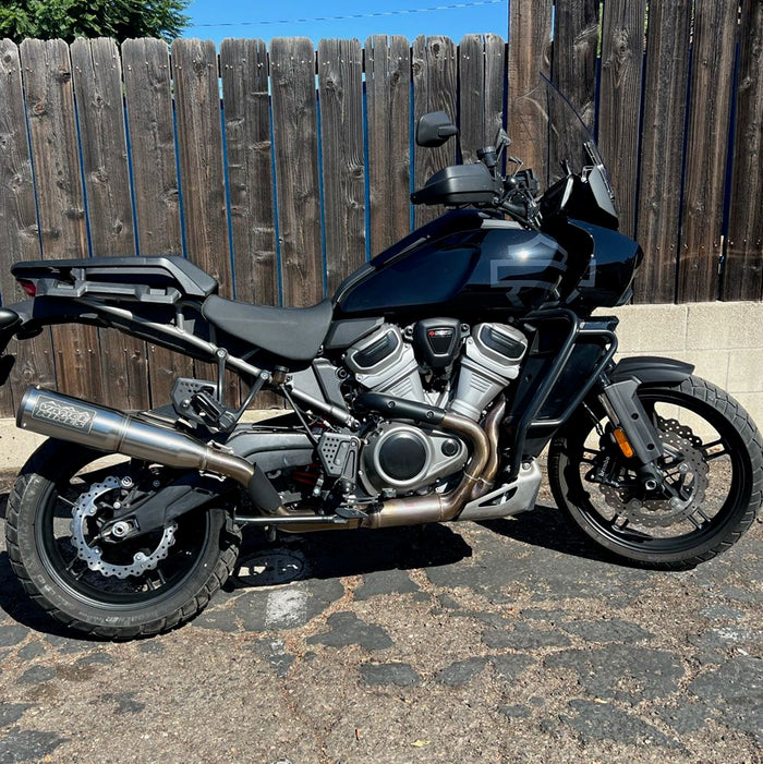 A TC Bros. Profile™ Front Floating Brake rotor for 2021-up Harley Pan America Mag Wheels motorcycle parked in front of a fence with TC Bros. modifications.