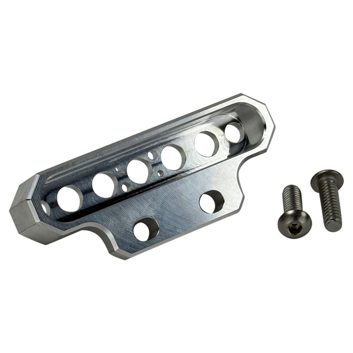 Two cylindrical motorcycle tachometer bezels from TC Bros., including the Pro Series 4 inch Gauge Relocation Bezel for Harley Davidson, in black and silver finishes with similar gauge faces featuring numbers and a red needle.