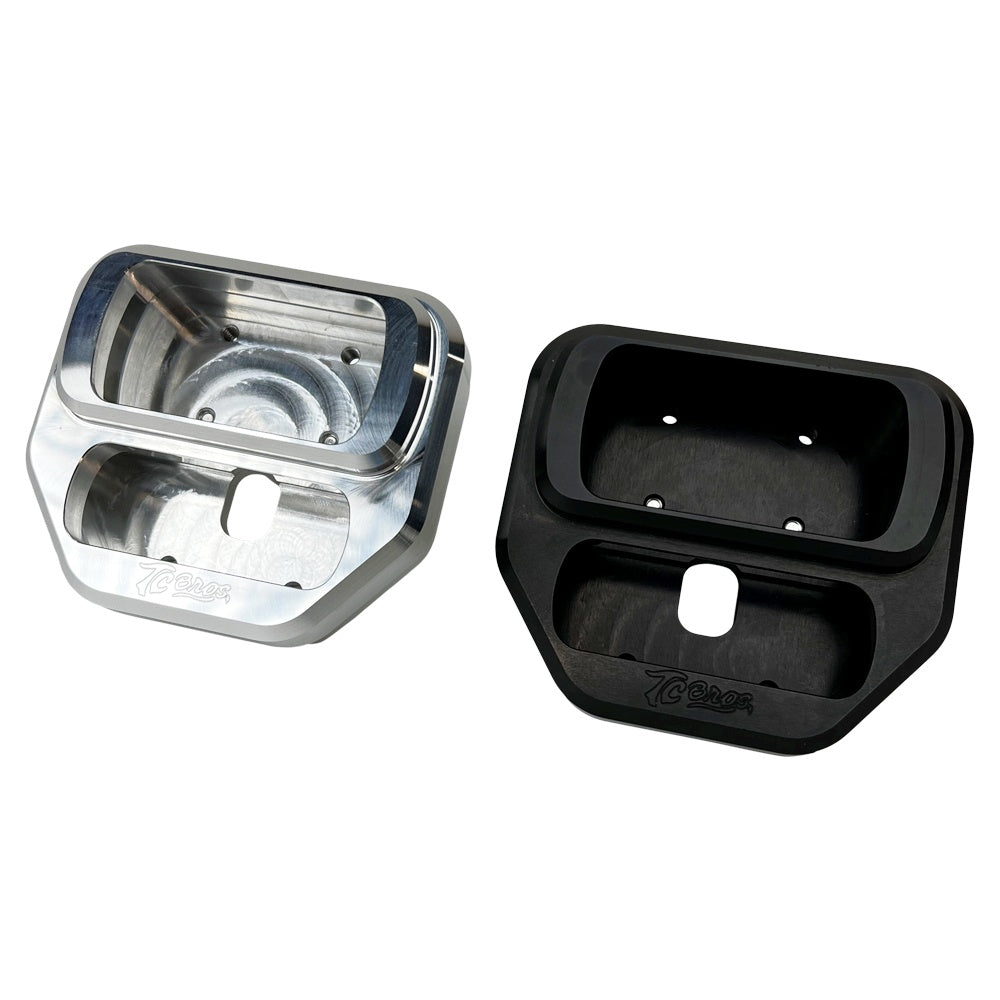 Two metallic TC Bros. Pro Series car mount bases for Harley Davidson M8 Softail, one in black anodized and the other in silver, feature rectangular cutouts and an engraved logo, blending form and function.