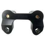 The TC Bros. Pro Series Handlebar Riser Adapter for 2015-2023 Harley-Davidson Road Glide, with a black and silver metal build, two cylindrical bases, and three mounting holes, is shown on a white background. Includes ignition lock retainer kit.