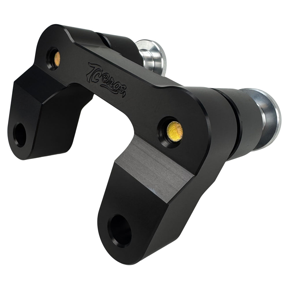 The TC Bros. Pro Series Riser Adapter features black anodized metal, two mounting holes, silver cylindrical ends, and engraved branding—ideal for upgrading 2006-2013 Harley-Davidson Street Glide handlebars.