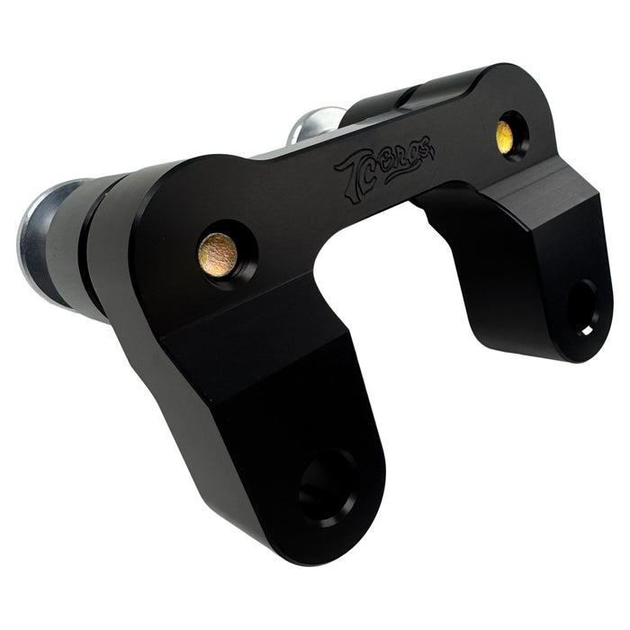 The TC Bros. Pro Series Riser Adapter features black anodized metal, two mounting holes, silver cylindrical ends, and engraved branding—ideal for upgrading 2006-2013 Harley-Davidson Street Glide handlebars.