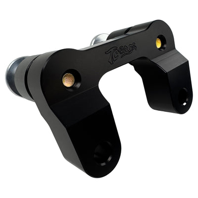The TC Bros. Pro Series Riser Adapter features black anodized metal, two mounting holes, silver cylindrical ends, and engraved branding—ideal for upgrading 2006-2013 Harley-Davidson Street Glide handlebars.