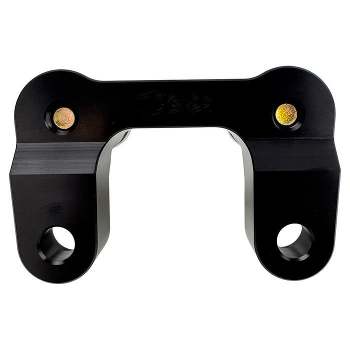 The TC Bros. Pro Series Riser Adapter features black anodized metal, two mounting holes, silver cylindrical ends, and engraved branding—ideal for upgrading 2006-2013 Harley-Davidson Street Glide handlebars.