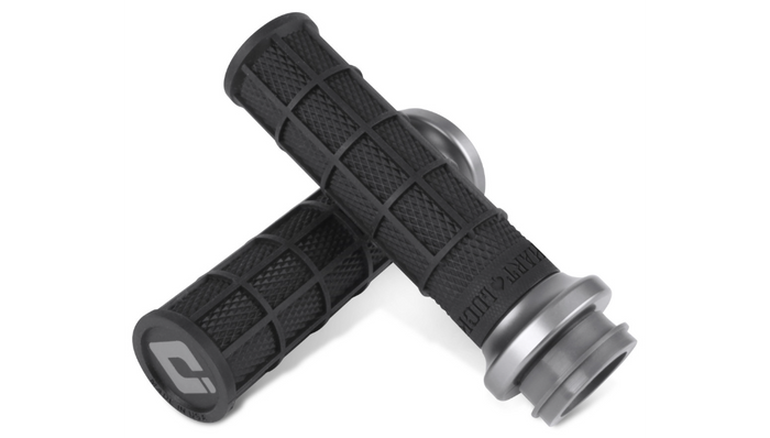 Seven pairs of ODI Hart-Luck Lock-on Grips for Harley-Davidson Cable Throttle, featuring black textured MX-style full-waffle handles with end caps in red, black, silver, or bronze—also suitable for bicycles.