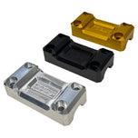Three CNC-machined Top Clamps for TC Bros. Pro Series Truss Risers by TC Bros. in silver, black, and gold are displayed on a white background. Each clamp has four corner holes and engraved details in the center.
