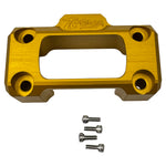 Close-up of a TC Bros. Digital Gauge Top Clamp for Pro Series Truss Riser on a Harley-Davidson handlebar, featuring yellow mounts, rearview mirrors, control buttons, and digital display, photographed outdoors on pavement.