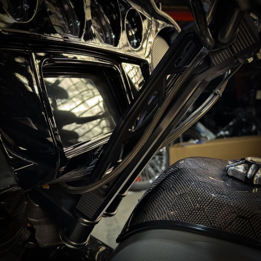 The TC Bros. Pro Series Riser Adapter for 2006-2023 Harley Davidson Street Glide features a black metal bracket with two threaded holes, silver washers, and gold bolts—shown on a white background. Perfect for performance upgrades.