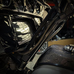The TC Bros. Pro Series Riser Adapter for 2006-2023 Harley Davidson Street Glide features a black metal bracket with two threaded holes, silver washers, and gold bolts—shown on a white background. Perfect for performance upgrades.
