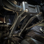 The TC Bros. Pro Series Riser Adapter for 2006-2023 Harley Davidson Street Glide features a black metal bracket with two threaded holes, silver washers, and gold bolts—shown on a white background. Perfect for performance upgrades.