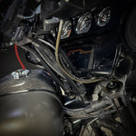 The TC Bros. Pro Series Handlebar Riser Adapter fits 2006-2023 Harley-Davidson Street Glide and includes an Ignition Lock Eliminator Kit—features a black metal bracket, gold bolts, and silver washers.