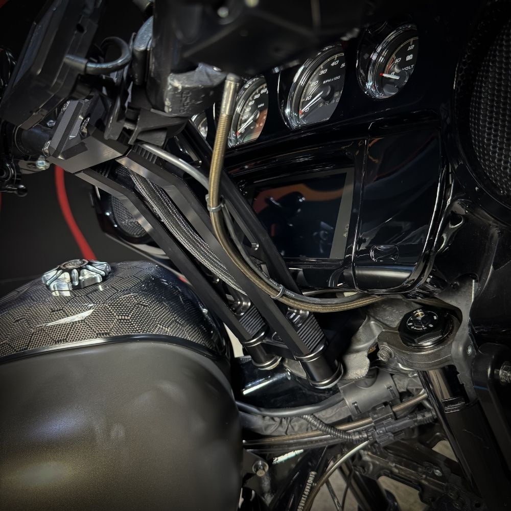 The TC Bros. Pro Series Riser Adapter for 2006-2023 Harley Davidson Street Glide features a black metal bracket with two threaded holes, silver washers, and gold bolts—shown on a white background. Perfect for performance upgrades.