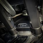 The TC Bros. Pro Series Handlebar Riser Adapter fits 2006-2023 Harley-Davidson Street Glide and includes an Ignition Lock Eliminator Kit—features a black metal bracket, gold bolts, and silver washers.