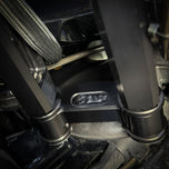 The TC Bros. Pro Series Riser Adapter for 2006-2023 Harley Davidson Street Glide features a black metal bracket with two threaded holes, silver washers, and gold bolts—shown on a white background. Perfect for performance upgrades.
