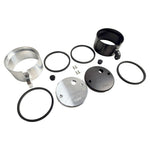 Two cylindrical motorcycle tachometer bezels from TC Bros., including the Pro Series 4 inch Gauge Relocation Bezel for Harley Davidson, in black and silver finishes with similar gauge faces featuring numbers and a red needle.
