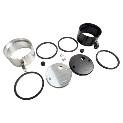 Two cylindrical motorcycle tachometer bezels from TC Bros., including the Pro Series 4 inch Gauge Relocation Bezel for Harley Davidson, in black and silver finishes with similar gauge faces featuring numbers and a red needle.