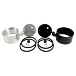 Two cylindrical motorcycle tachometer bezels from TC Bros., including the Pro Series 4 inch Gauge Relocation Bezel for Harley Davidson, in black and silver finishes with similar gauge faces featuring numbers and a red needle.