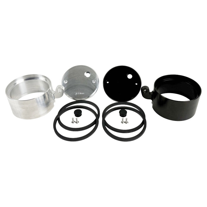 Two cylindrical motorcycle tachometer bezels from TC Bros., including the Pro Series 4 inch Gauge Relocation Bezel for Harley Davidson, in black and silver finishes with similar gauge faces featuring numbers and a red needle.
