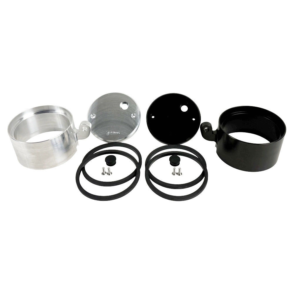 Two cylindrical motorcycle tachometer bezels from TC Bros., including the Pro Series 4 inch Gauge Relocation Bezel for Harley Davidson, in black and silver finishes with similar gauge faces featuring numbers and a red needle.