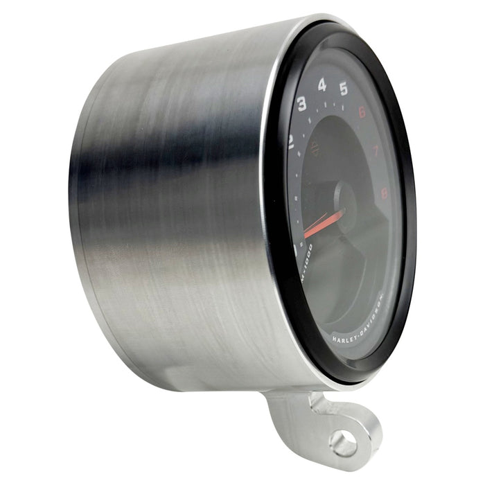 Two cylindrical motorcycle tachometer bezels from TC Bros., including the Pro Series 4 inch Gauge Relocation Bezel for Harley Davidson, in black and silver finishes with similar gauge faces featuring numbers and a red needle.