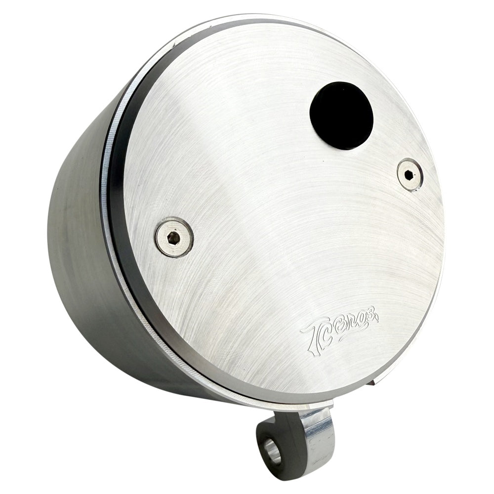 Two cylindrical motorcycle tachometer bezels from TC Bros., including the Pro Series 4 inch Gauge Relocation Bezel for Harley Davidson, in black and silver finishes with similar gauge faces featuring numbers and a red needle.