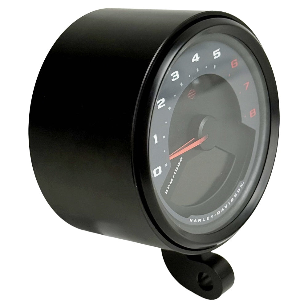 Two cylindrical motorcycle tachometer bezels from TC Bros., including the Pro Series 4 inch Gauge Relocation Bezel for Harley Davidson, in black and silver finishes with similar gauge faces featuring numbers and a red needle.