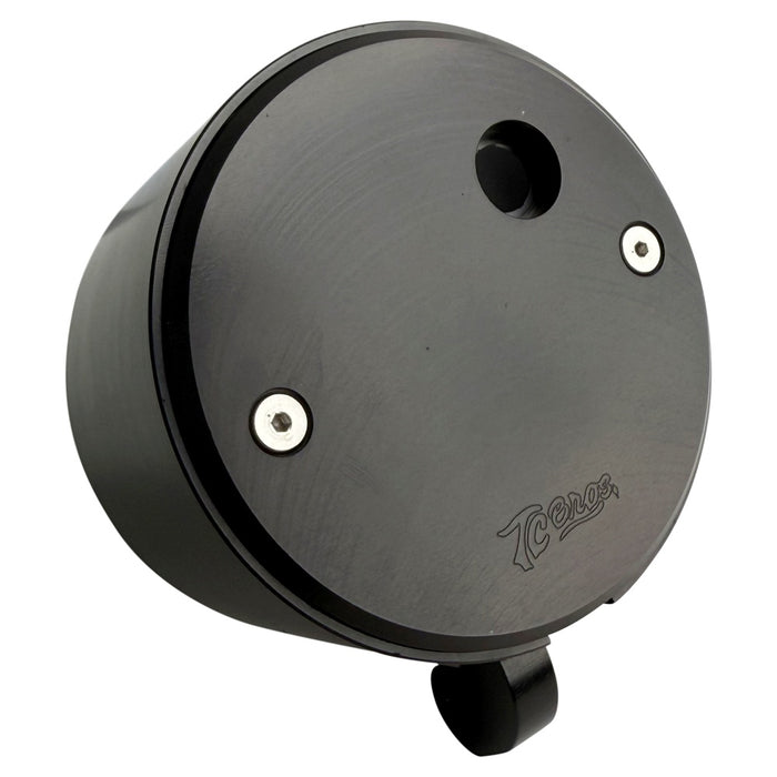 Two cylindrical motorcycle tachometer bezels from TC Bros., including the Pro Series 4 inch Gauge Relocation Bezel for Harley Davidson, in black and silver finishes with similar gauge faces featuring numbers and a red needle.