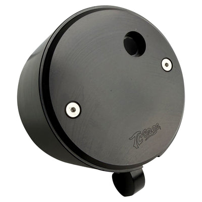 Two cylindrical motorcycle tachometer bezels from TC Bros., including the Pro Series 4 inch Gauge Relocation Bezel for Harley Davidson, in black and silver finishes with similar gauge faces featuring numbers and a red needle.